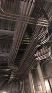 Overhead conduit racks installed in an industrial facility