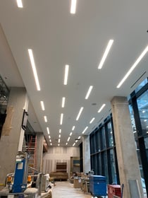 Commercial lobby with linear and pendant lighting installed by Adrian Electric