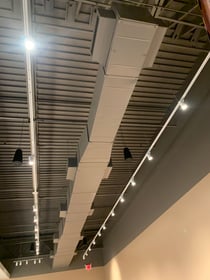 Retail space with track lighting and open ceiling installed by Adrian Electric