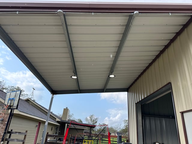 LED lights installed under a covered patio on a metal building
