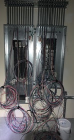 Panel being wired with organized branch circuit conductors