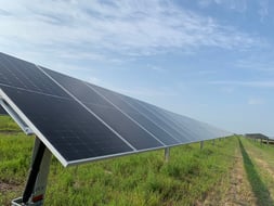 Rows of ground-mounted solar panels on an installation site