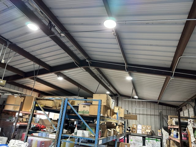 LED high-bay lights installed in a steel-frame warehouse in Rosenberg, TX