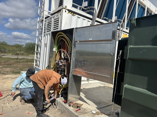 Adrian Electric electricians terminating service conductors in a 480-volt fused service disconnect near Victoria, TX