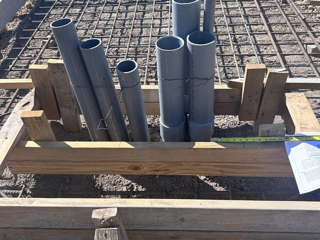PVC conduit stub-ups set in the transformer pad form before the concrete pour